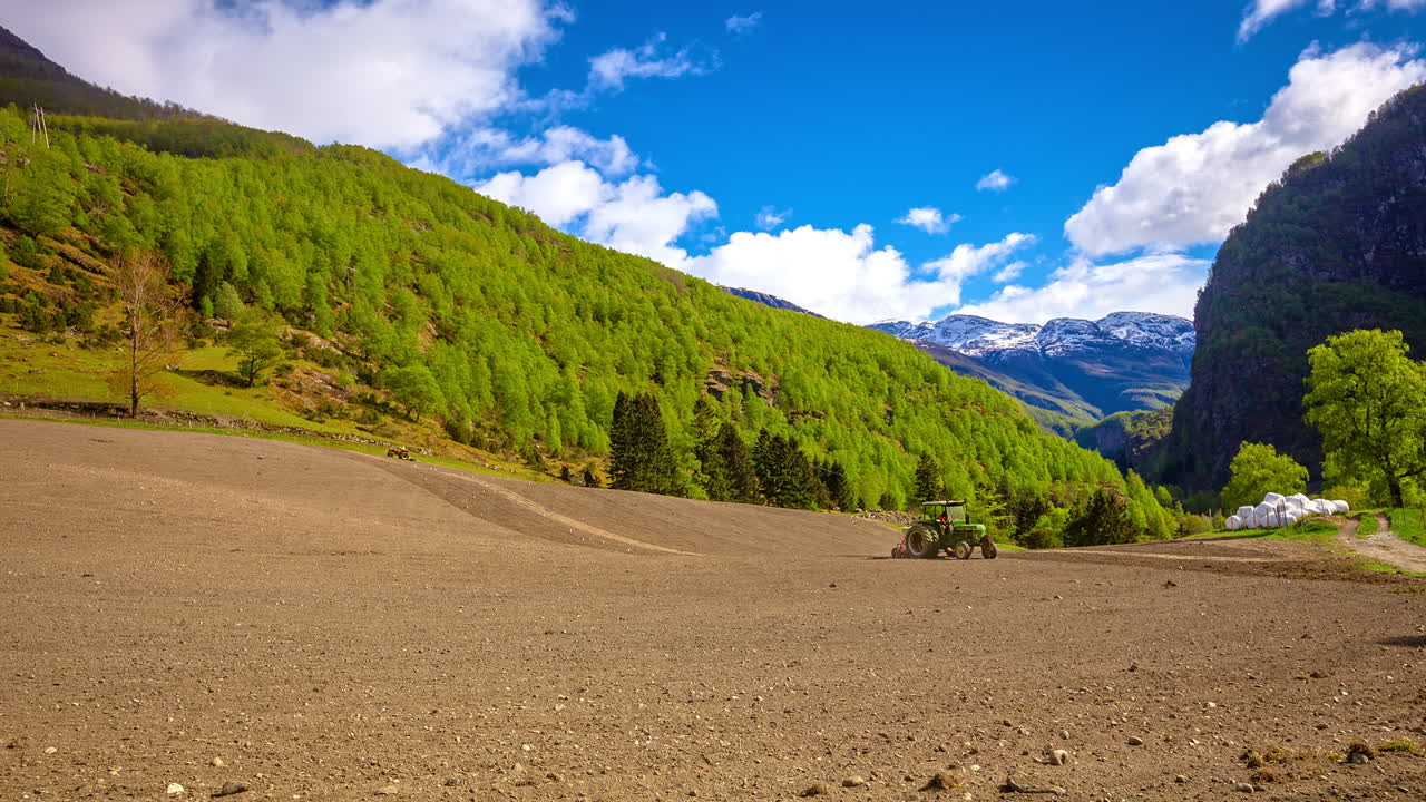 tractors plowing and preparing land for cultivation in high altitude mountain range