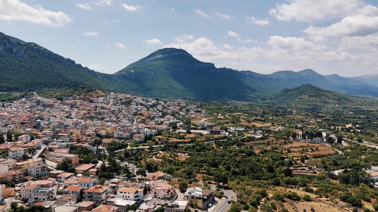 Dorgali town view with mountains, sunshine, and vast landscape in Sardegna