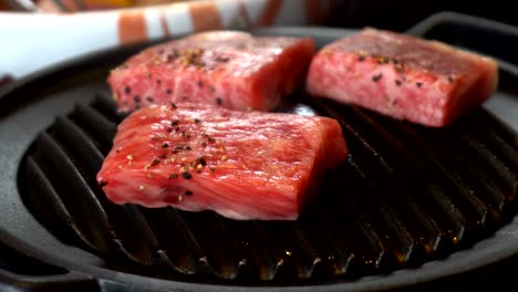 cooking delicious juicy meat steaks on the grill on fire. grillling premium beef hida in takayama japan