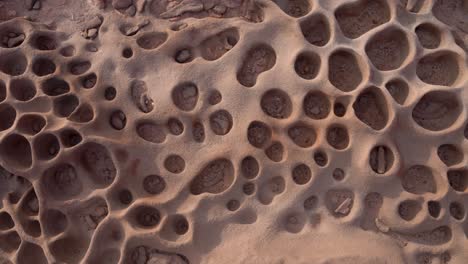 close up shot of tafoni formations in a clay pan in namibia