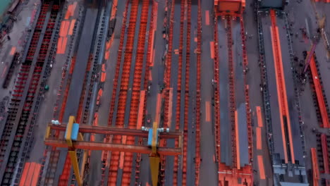 Close view shipyards steel industry port vessel factory real shot, construction of a large ship on a shipyard with cranes. A fragment of the case in the workshop of plant. Metal frame during assembly