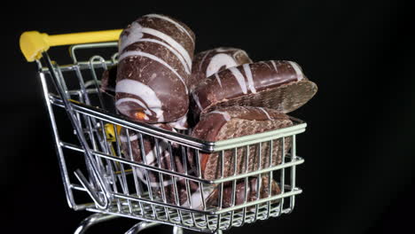 Sweets-In-A-Shopping-Trolley-On-A-Black-Background-4k-Video