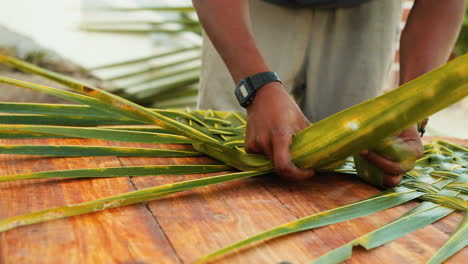 Young-African-male-crafting-a-palm-roof