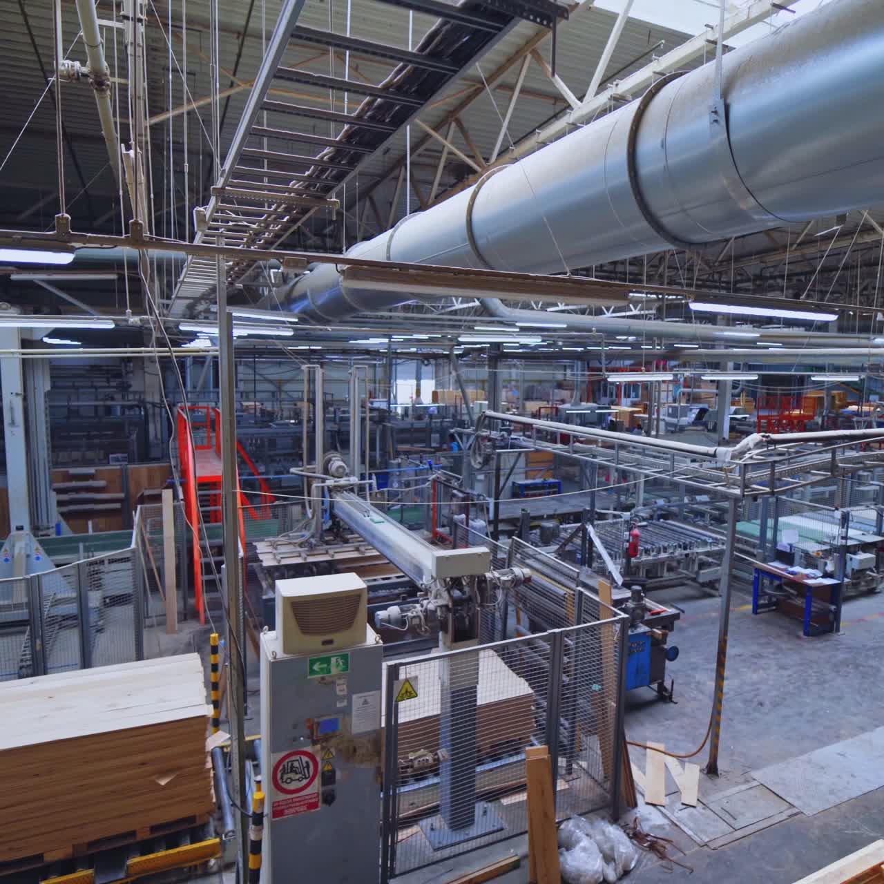 Industrial Wood Processing Factory with Automated Machinery and Stacked Lumber