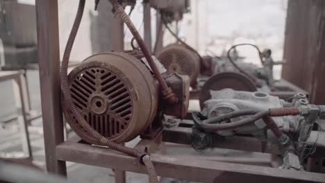 row of rusty pressure washers engines at an old abandoned car wash - slow motion