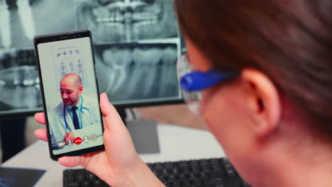 close up of nurse talking on video call with specialist dentistry doctor