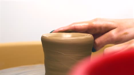 close footage of woman making pot from clay, pottery manufacturing