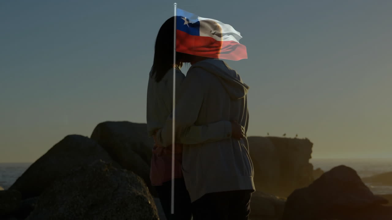 Embracing by sea, two people with Chilean flag animation overlay