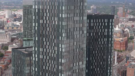 deansgate manchester aerial view close up descending modern geometric square glass skyscraper towers