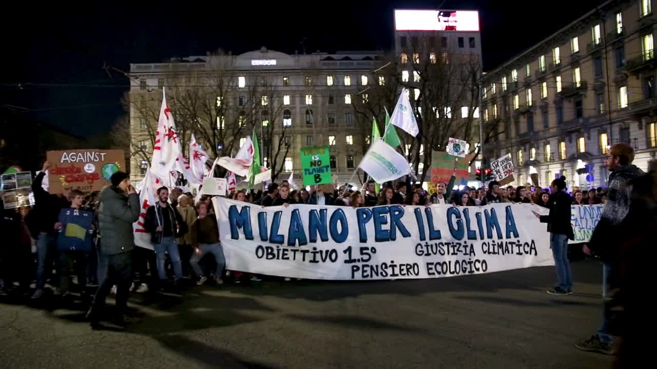 Global Strike for Climate Change. Thousands of people attend and fill streets in Piazzale Cadorna Milan. Youth guys raise placard and their voice for Friday for future with Greta Thunberg