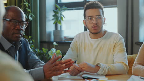 young student talking with teacher and group mates on english class