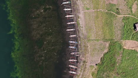 Overhead-Drone-View-of-Fishing-Boats-on-Shore-of-Lake-Mainit,-Philippines