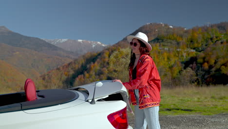 woman enjoying a scenic drive in a convertible through autumn mountains