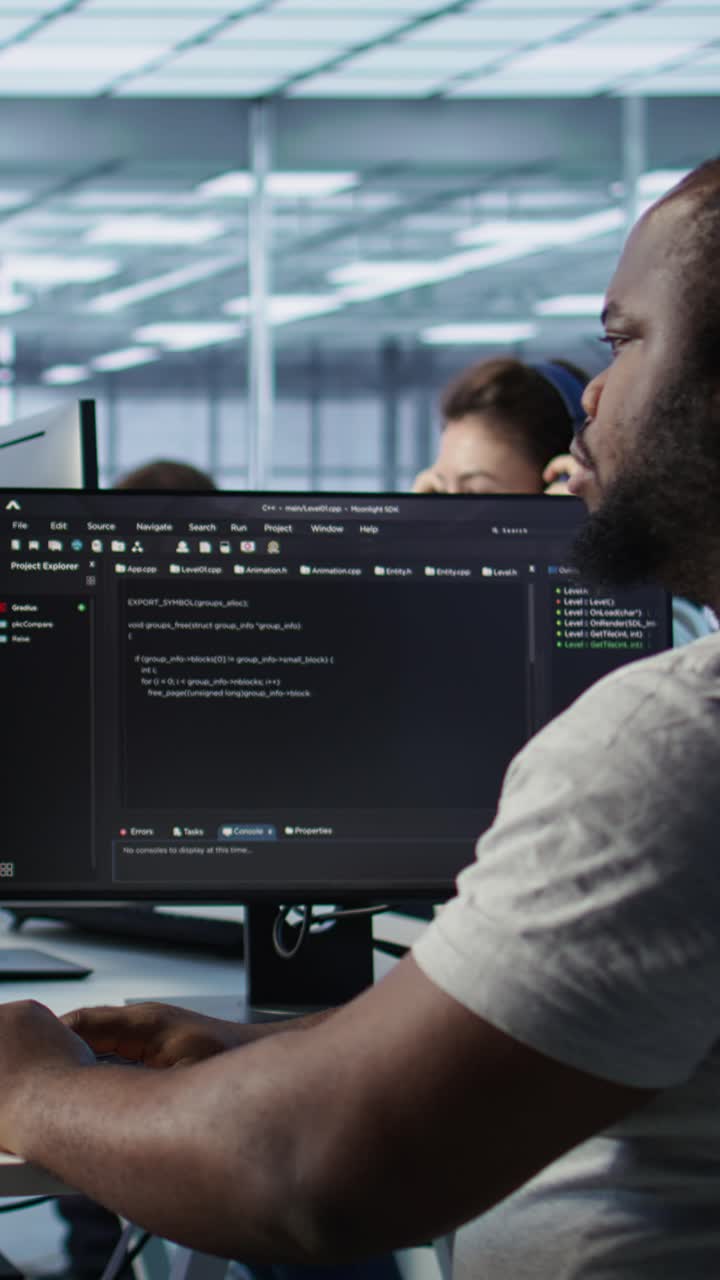 African American Programmer Typing Code on Computer in Modern Office