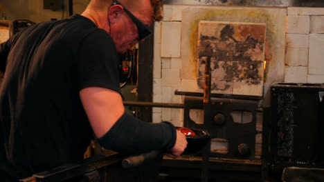 glassblower shaping a molten glass