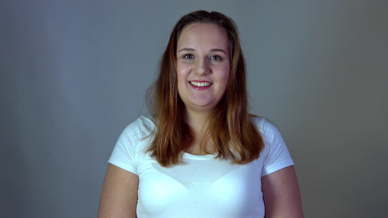 Portrait of chubby and body positive woman in casual tshirt with smiling expression
