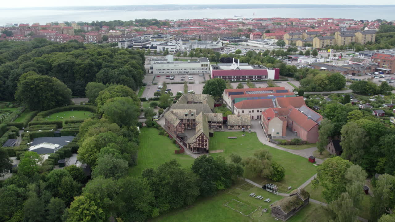 Fredriksdal Museum and Gardens, Helsingborg, Sweden - An Aerial View of a Charming Historic Village Set Amid Wide Green Spaces and a Coastal Town in the Distance - Aerial Drone Shot
