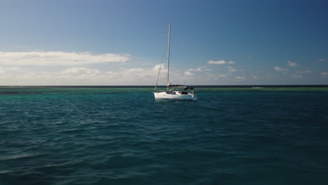paralaje aéreo bajo alrededor del velero que se mueve hacia una isla tropical, isla de pinos