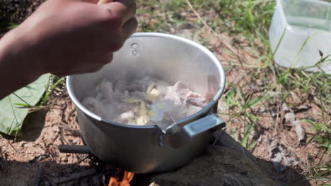 vietnamese hand cooking pork with ginger in a casserole