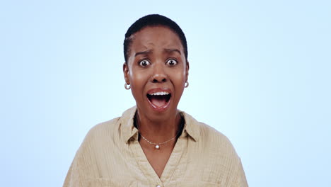 woman, face and shocked in studio on blue