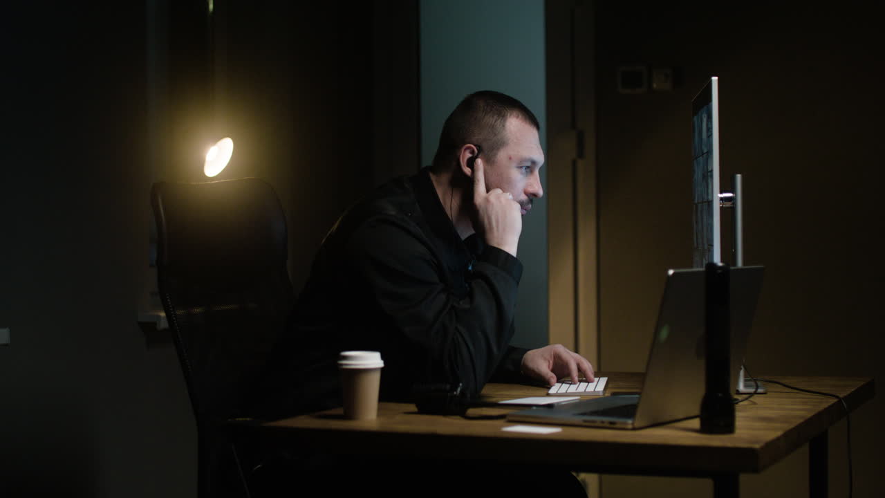 Man with keyboard in the hut at night