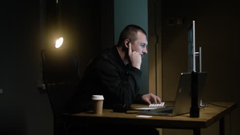 man with keyboard in the hut at night