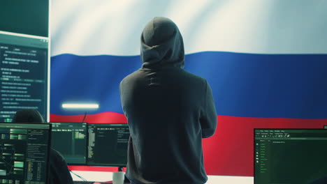 Russian-hacker-with-a-hood-installing-panic-by-misconception-and-manipulation