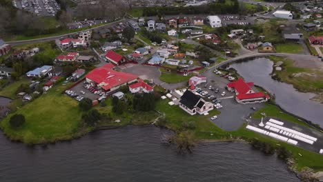 Ohinemutu-Maori-Village-aerial-birds-eye-view-of-Meeting-building,-War-Memorial,-School,-Square-and-housing-area-in-Rotorua,-New-Zealand