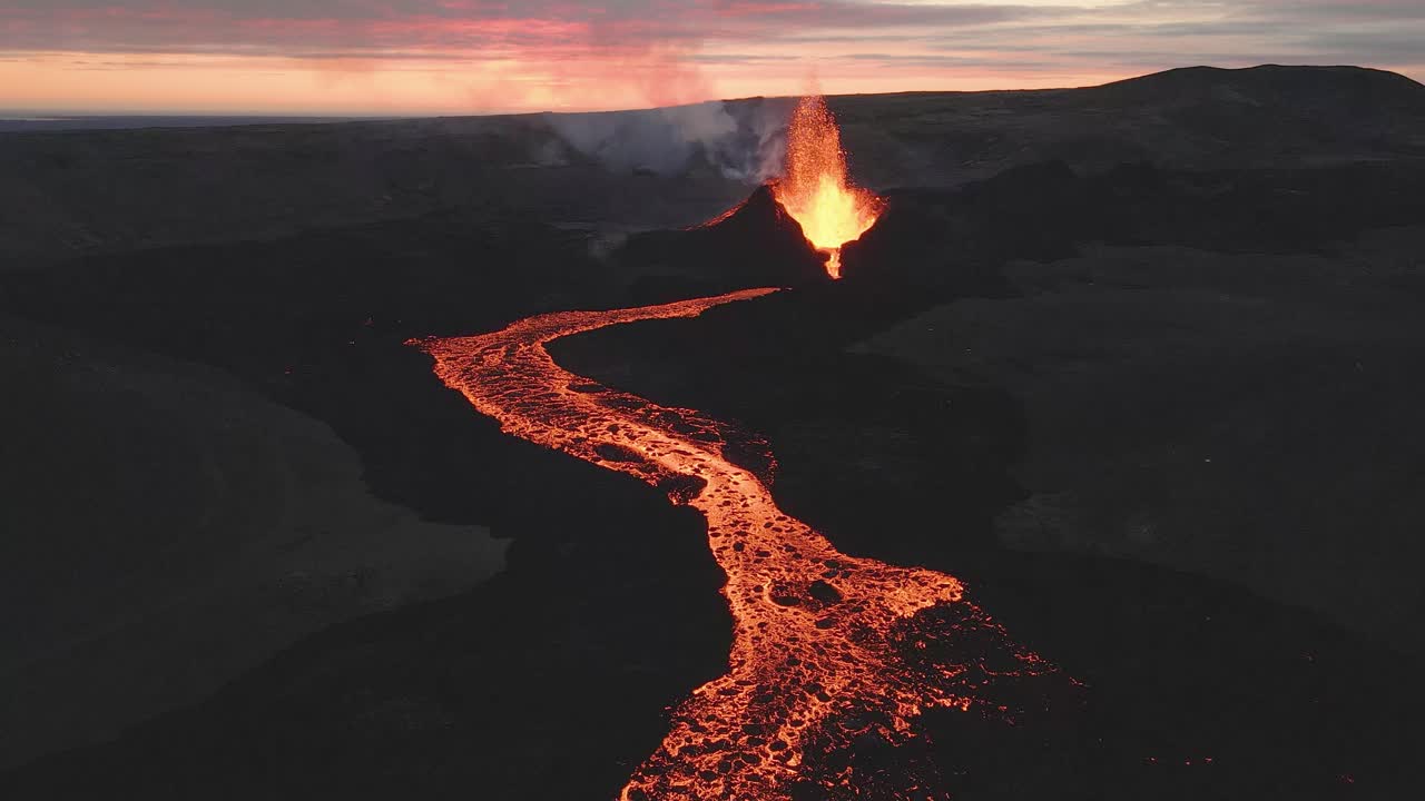 Volcano erupting magma and lava river at sunset, Iceland