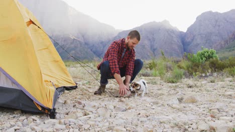 -Caucasian-man-setting-up-camping-tent