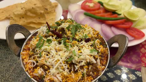 indian dish with cheese, salad, and crisps
