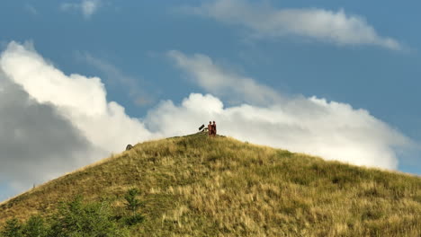 statues on top of a mountain parallax effect aerial shot french alps sunny day