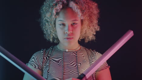 neon portrait of a woman with lightsabers