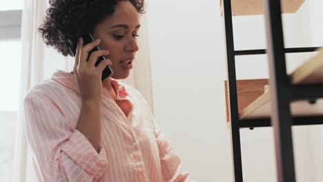 Smiling-Manager-Calling-Smartphone-at-Workplace-Closeup-Happy-Woman-Consulting.Smiling-manager-calling-smartphone-at-workplace-closeup.-Happy-woman-lawyer-consulting-client-by-mobile-phone-working-in-office.-Young-businesswoman-discussing-good-news-looking-successful-report.