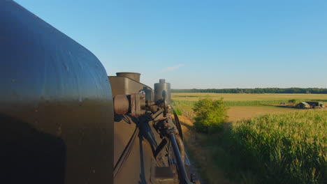 moving steam locomotive blows on whistle