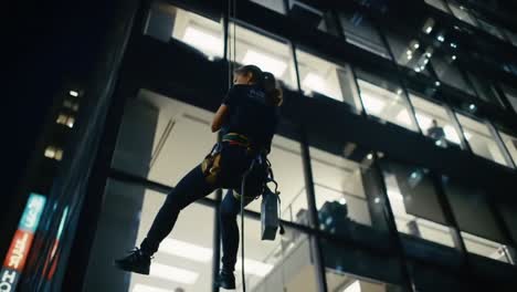 an adventurous rooftop cleaner suspended in midair, skillfully maintaining the high-rise building's glass front facade under city lights