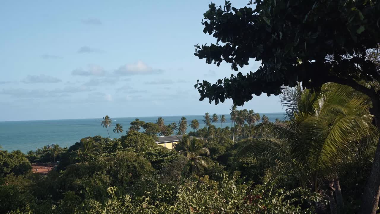 Landscape shot of the beautiful tropical Atlantic ocean from a lookout above Penha beach in Paraiba, Brazil near Jo&atilde;o Pessoa with exotic foliage below and crystal clear blue water in the distance