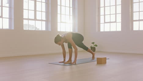 beautiful yoga woman practicing downward-facing dog split pose enjoying fitness lifestyle exercising in studio stretching flexible body training early morning meditation on exercise mat