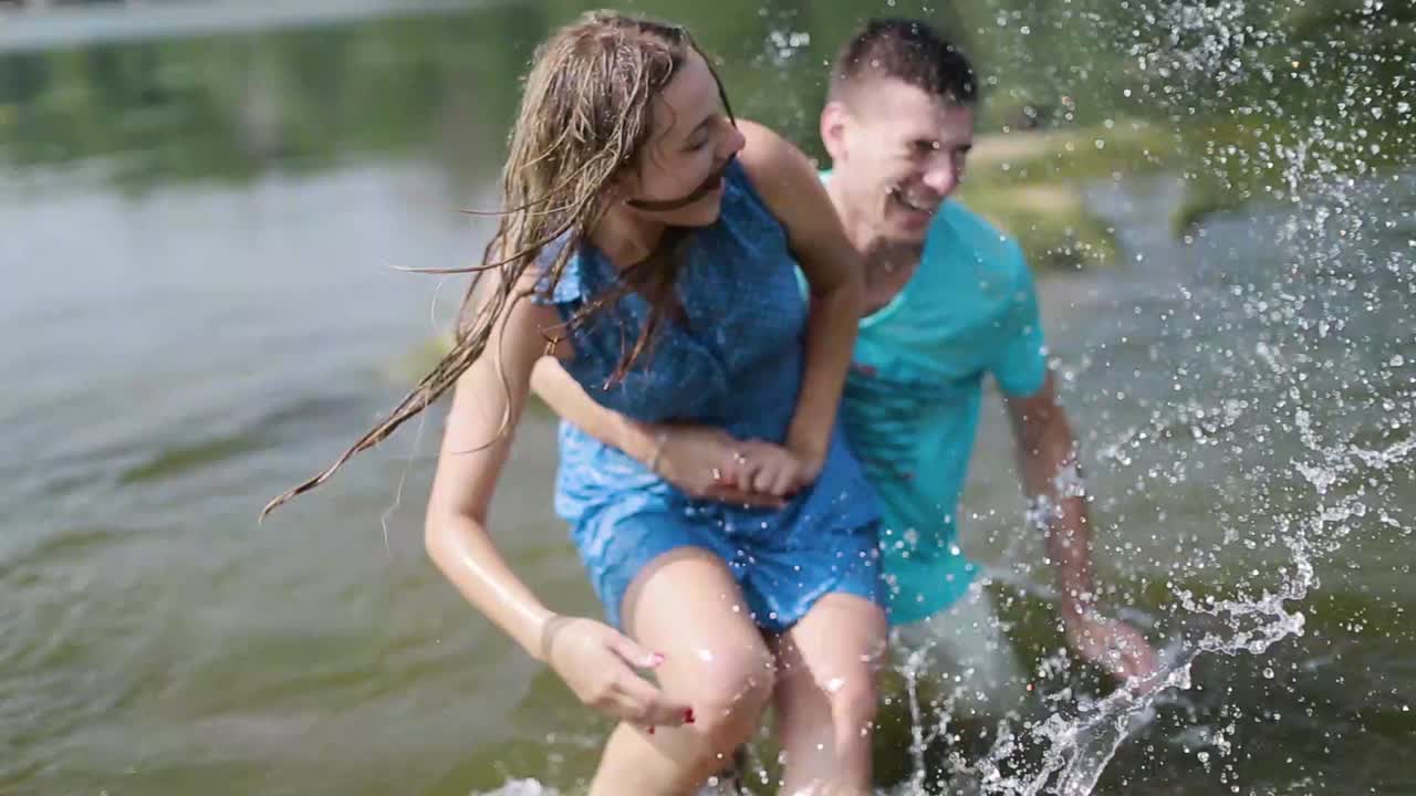 Couple Resting On River Bank. Smiling couple resting on river bank in nature