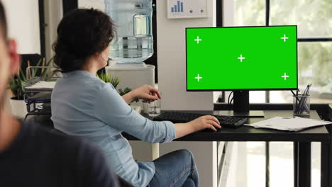 Office employee looks at greenscreen