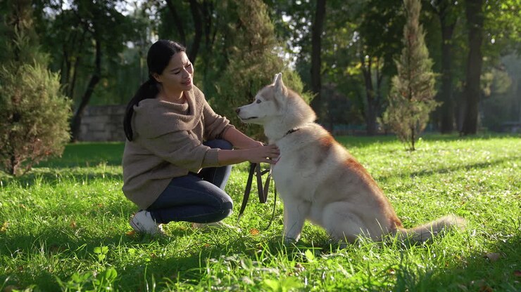 Pet owner kissing her dog