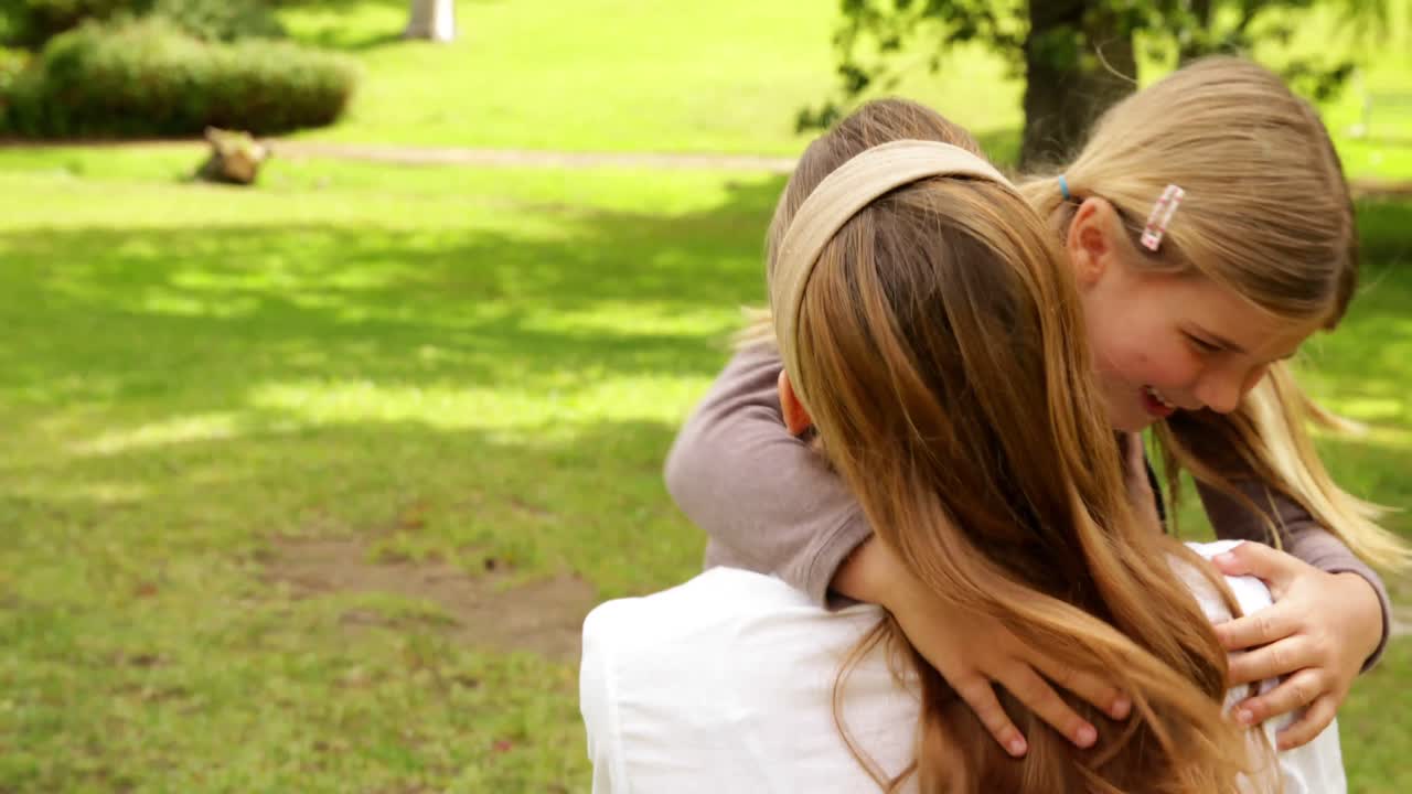 Madre e figlia felici che giocano insieme al parco