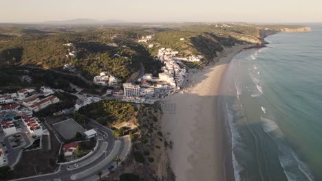 panning aerial view of coastal village praia da salema beach in algarve portugal