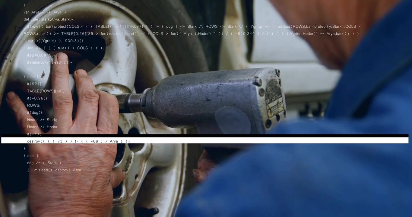 Mechanic hands placing socket pressing wrench loosening lug nut for wheel repair amid code overlay