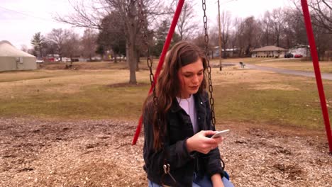 4k-footage-of-a-gorgeous-college-brunette-teenager-with-a-serious-look-checking-messages-on-a-smart-phone