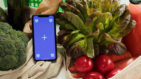 smartphone displayed on a table with fresh produce