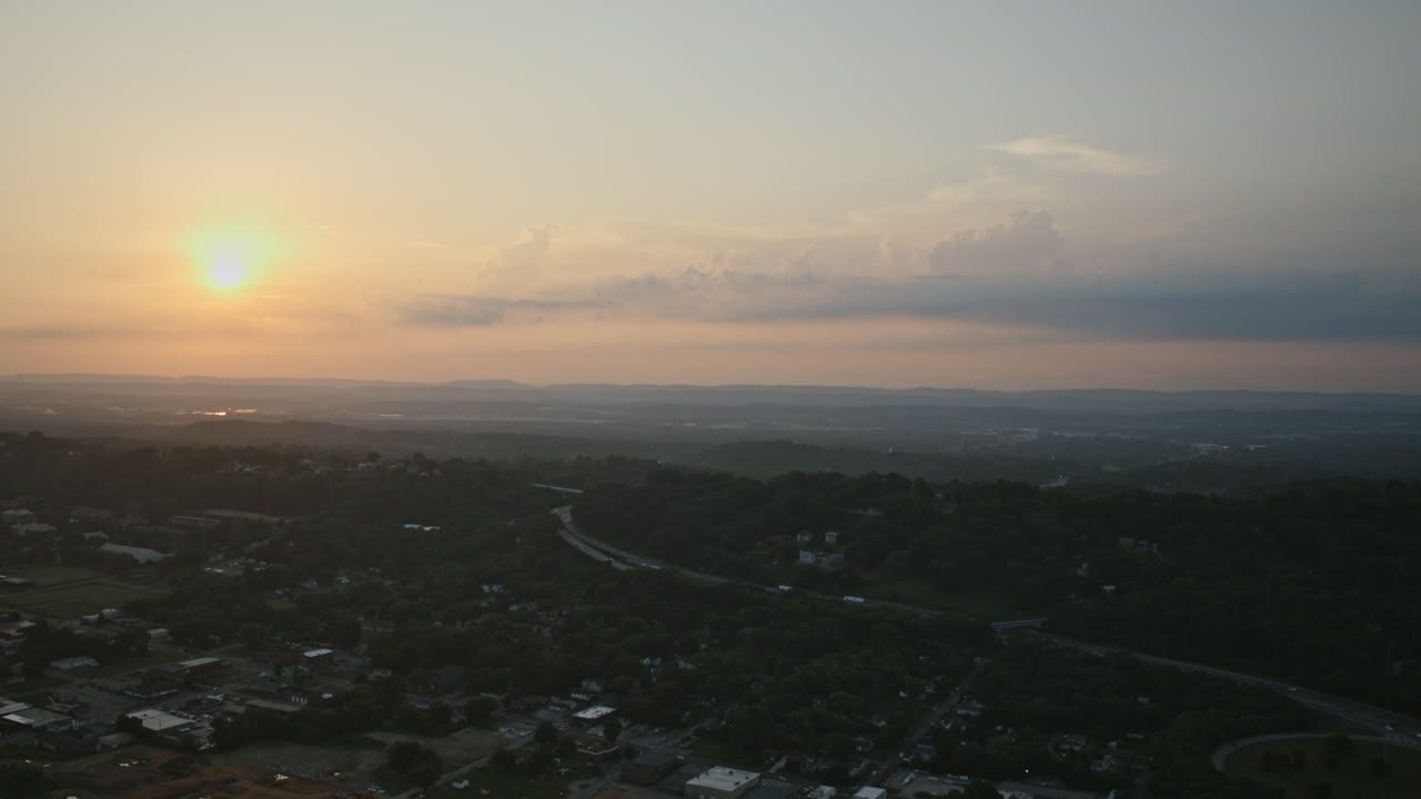 Aerial hyperlapse zooming over Missionary Ridge after sunrise with I-24 highway in foreground.