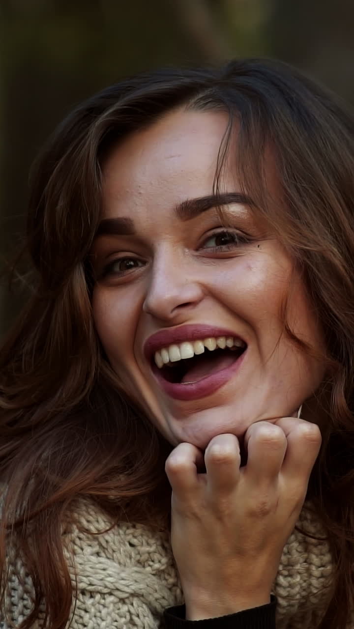 Beautiful female dreaming in the autumn park. Cheerful beautiful girl outdoors on beautiful fall day