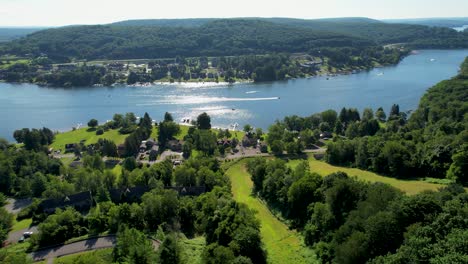 drone reverse flyaway from lake up over ski slopes in summer deep creek lake maryland