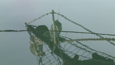 Reflection-in-water-of-mast